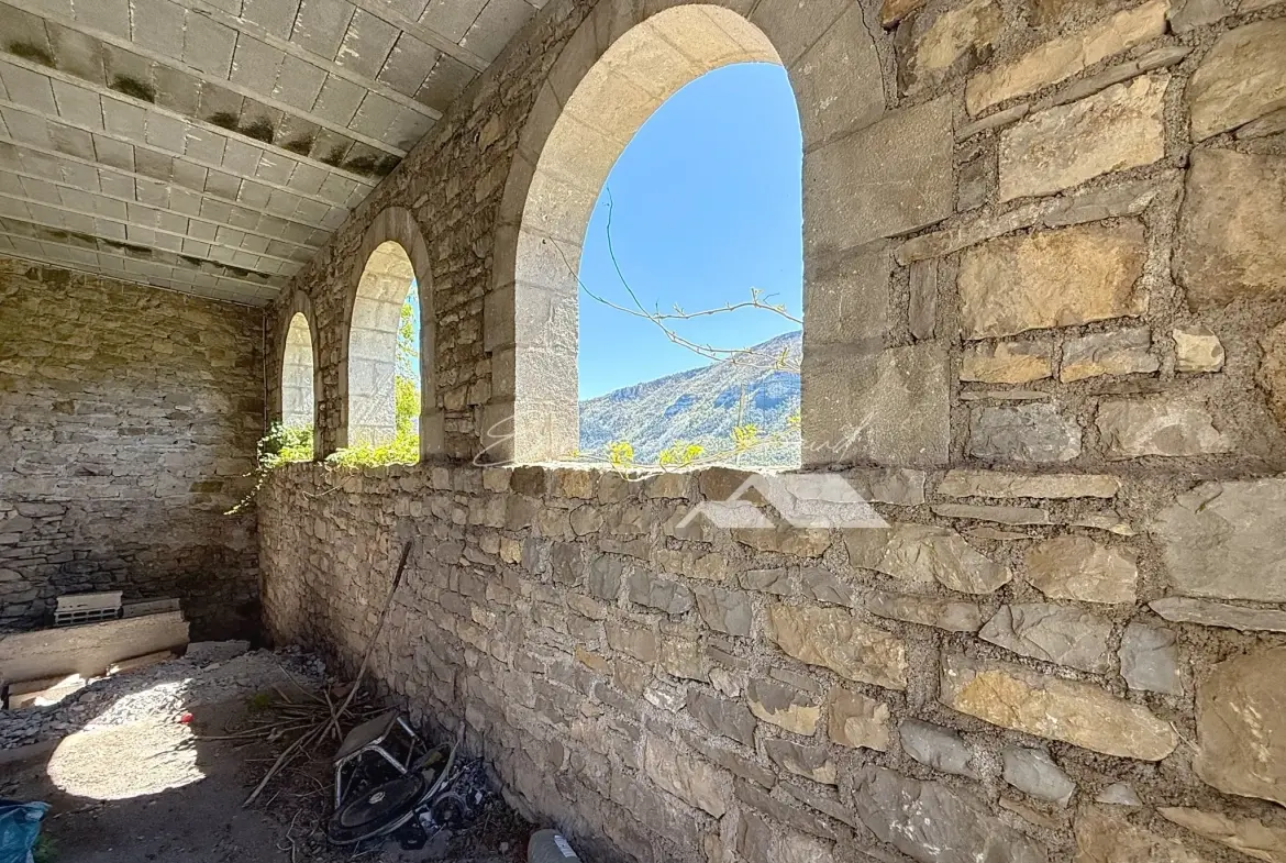 Maison en pierre avec vue spectaculaire et jardin à Mostuejouls, idéale pour nature et tranquillité 
