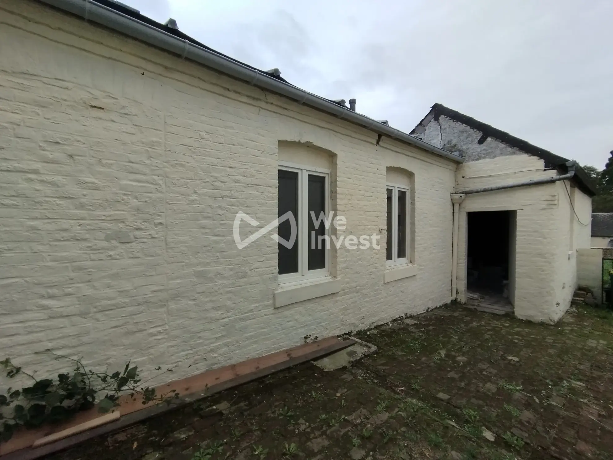 Immeuble de rapport à Fourmies avec potentiel de rénovation et jardin 