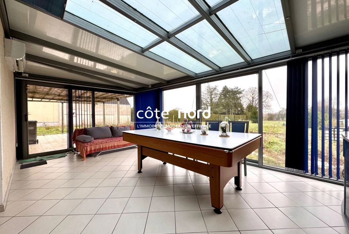 Pavillon individuel de plain-pied proche Caudry avec garage et grande véranda 