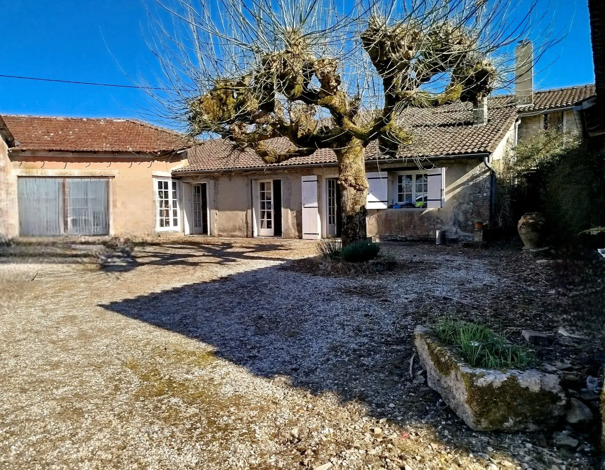 Maison de village de plain-pied avec jardin, dépendances et potentiel de rénovation à Soussac 